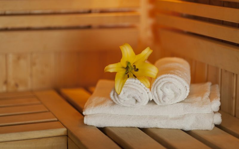 close-up-fresh-towels-yellow-lily-sauna